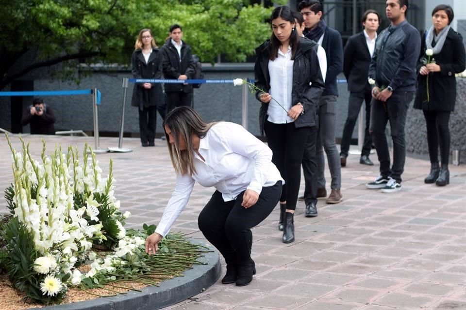 Las familias colocaron arreglos florales a un lado de la placa.