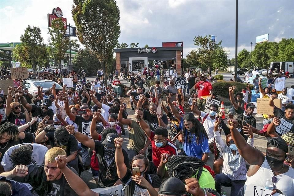 Personas participaron el domingo en un mitin en Atlanta contra el racismo y la violencia policial frente a un Wendys, donde la policía mató a Rayshard Brooks.