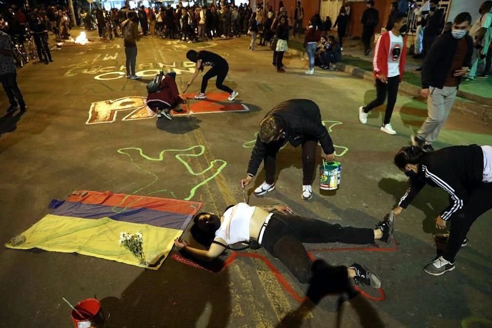 Un grupo de jóvenes pinta las calles del barrio Verbenal como protesta por la muerte de manifestantes en Bogotá.