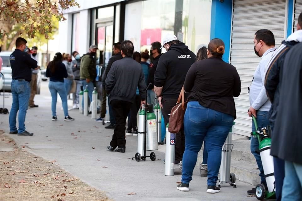 Decenas de personas hacen filas en negocios como MediLab, frente al Hospital Universitario, para conseguir oxígeno para sus familiares enfermos.