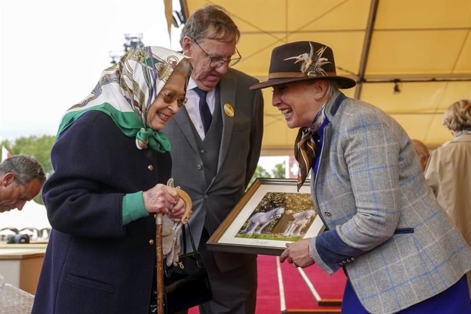 La Reina Isabel II de Gran Bretaña intercambia fotografías con Jane Rawden de Fell Pony Society, a la derecha, durante el Royal Windsor Horse Show en Windsor.