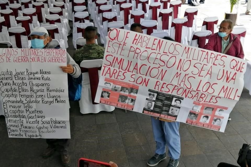 Inconformes con pancartas durante el acto oficial.