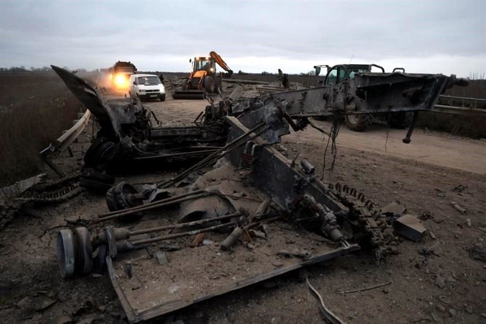 Autos y camiones transitan por caminos destruidos en Jersón.