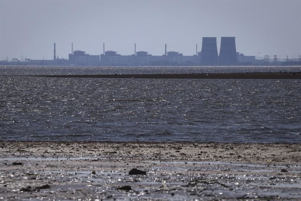 La central nuclear de Zaporiyia, la más grande de Europa, vista al fondo del embalse de Kajovka tras la rotura de la represa, en Energodar el 9 de junio de 2023.