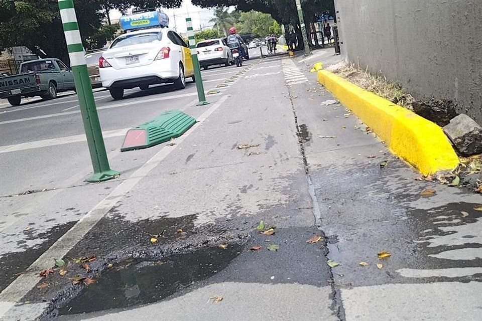 Uno de los baches en medio de la ciclovía se cubre con agua cuando llueve.