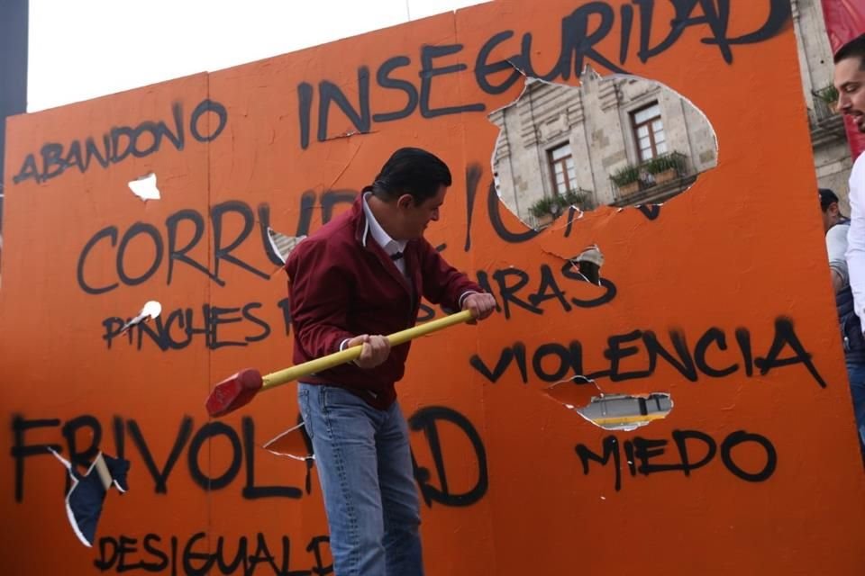 Con un mazo, 'Chema' rompió un muro naranja elaborado con unicel, en el cual se plasmaron palabras como 'Abandono', 'Inseguridad', 'Corrupción', 'Violencia' y 'Frivolidad'.