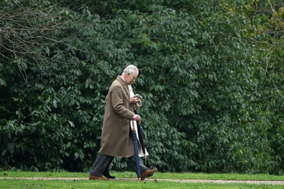 Reflexivo, el Rey Carlos III vistió con un traje completo de tonalidades verdes oscuras, acompañado de un saco café, a juego con sus zapatos.