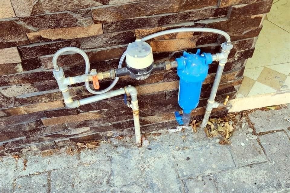 Aun en la banqueta, un usuario hizo una instalación para que no se registre en su cuenta todo el flujo de agua.