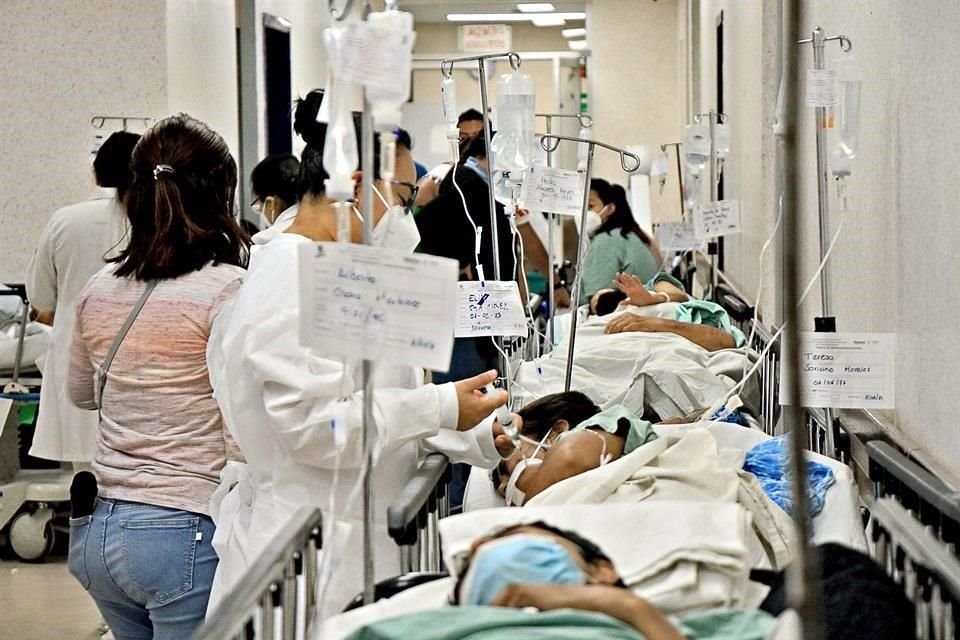 Pacientes del hospital esperan atención médica en los pasillos.