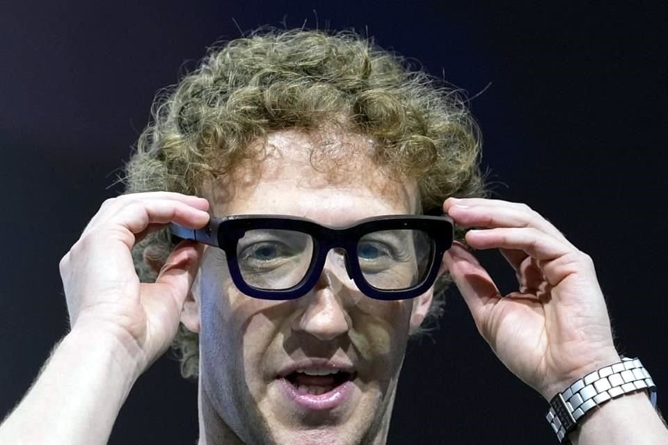 Mark Zuckerberg colocándose un par de gafas de realidad aumentada Orion en la conferencia Meta Connect.