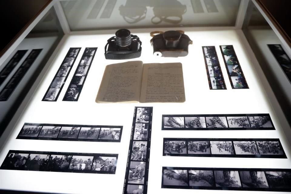 The exhibition includes his camera, notes, and contact sheets.