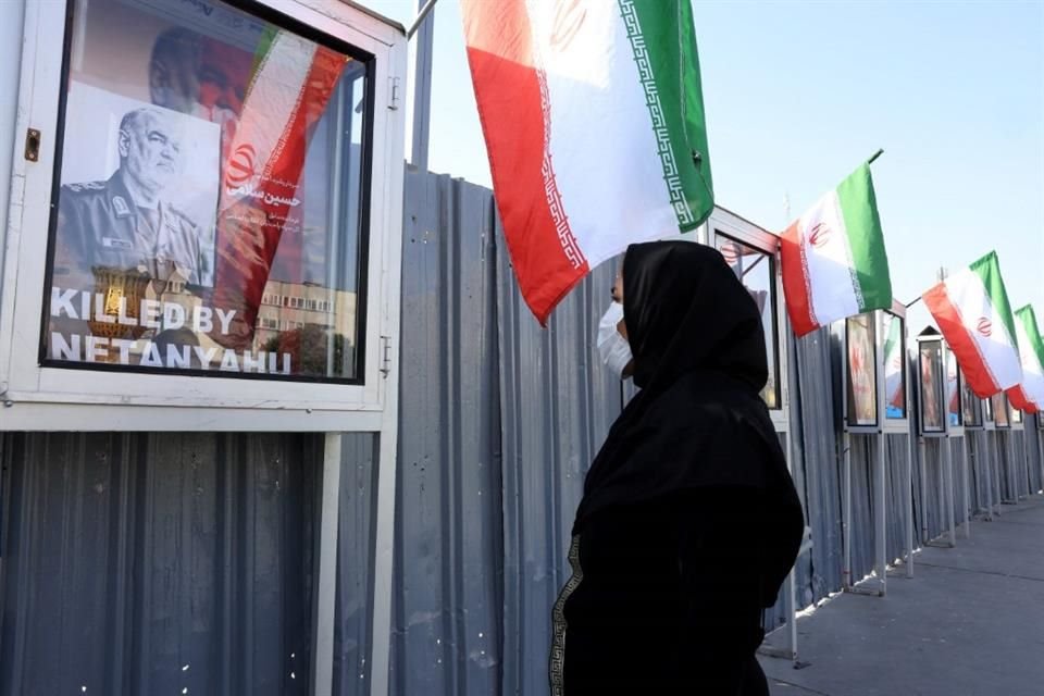 Una mujer iraní mira una imagen del líder de la Guardia Revolucionaria, asesinado en ataque israelí, el 23 de junio.