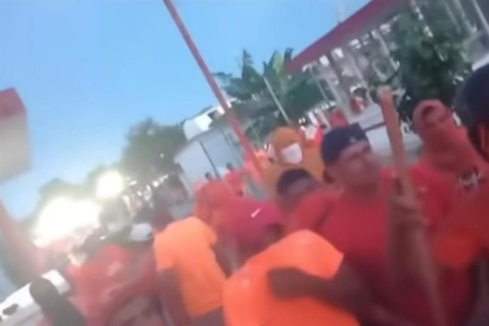 Reos con atuendos naranja y algunos armados con palos fueron captados en video durante una protesta.