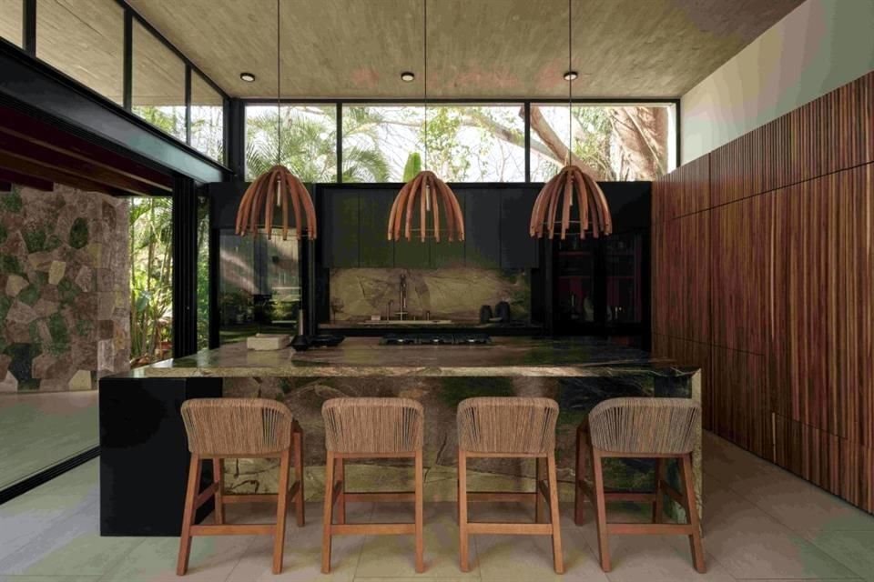 Concreto, piedra y madera destacan en el interiorismo de la residencia.